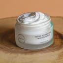 Jar of moisturizing cream on a wooden board